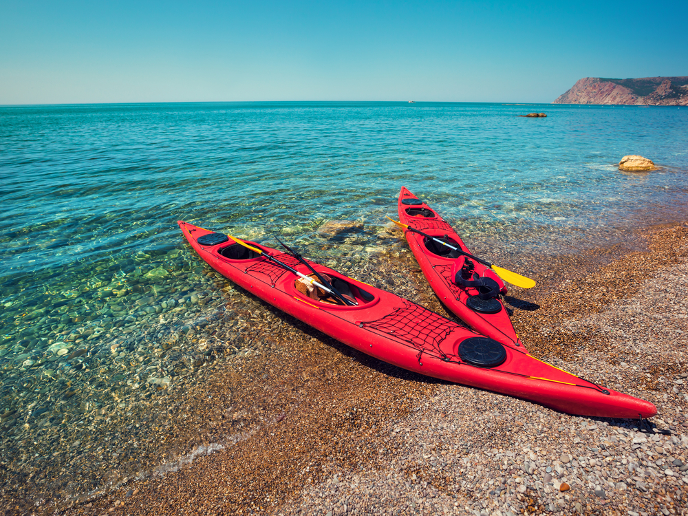 Kayaks on beach as adults fond some alone time - Image courtesy of Shutterstock