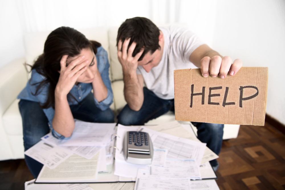 Couple asking for help with debt - image courtesy of shutterstock 
