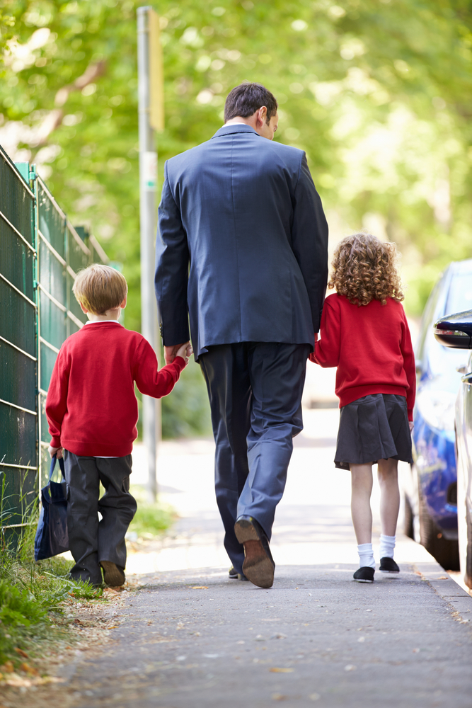 Dad walking his children to school - image courtesy of shutterstock