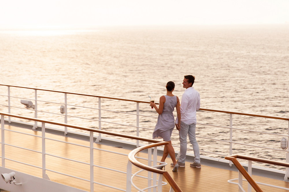 couple enjoying the view from their cruise ship - image courtesy of shutterstock