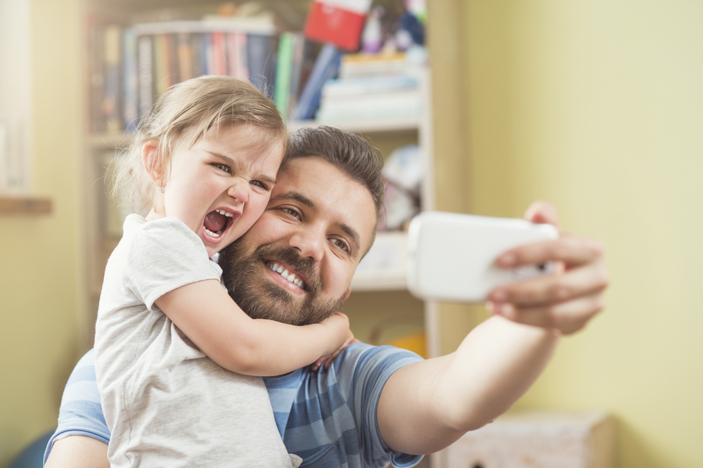 Dad & Daughter selfie image courtesy of Shutterstock
