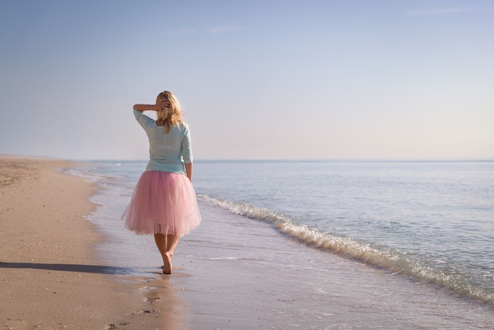 woman walking along beach alone